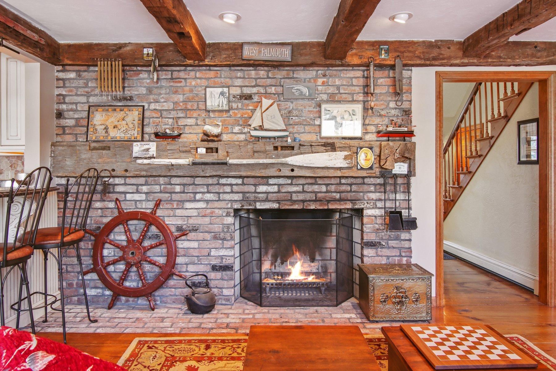4 Shapquit Bars Road Falmouth, MA 02540 - Photo 9 of 45 a living room with furniture a flat screen tv and a fireplace