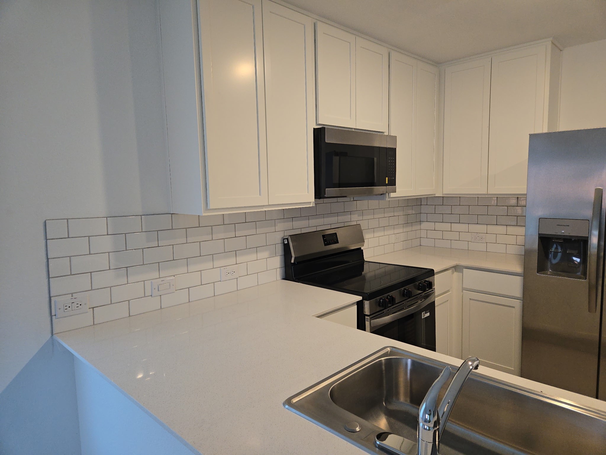16059 Tallis Drive Conroe, TX 77303 - Photo 1 of 10 a kitchen with sink a microwave a stove and refrigerator