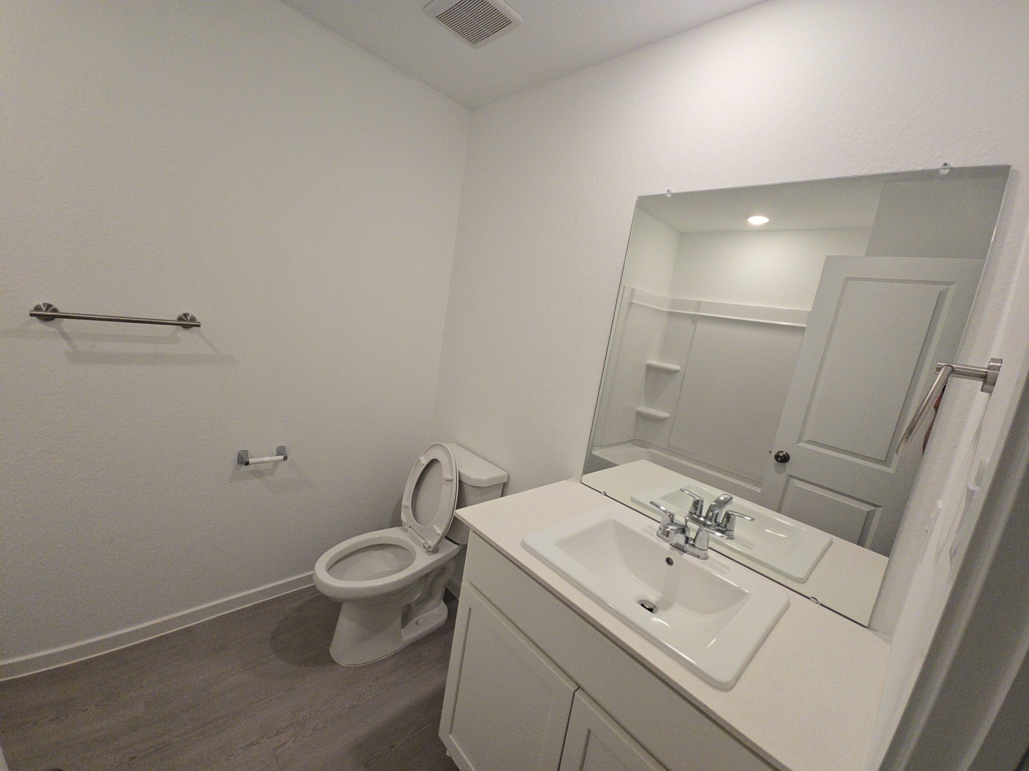 16059 Tallis Drive Conroe, TX 77303 - Photo 3 of 10 a bathroom with a toilet sink and mirror