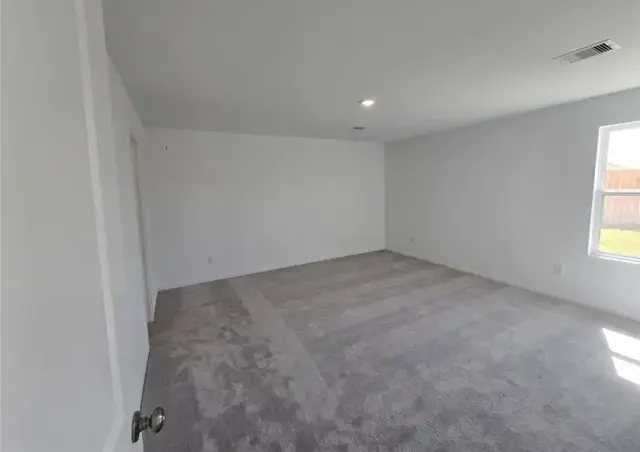 an empty room with a windows