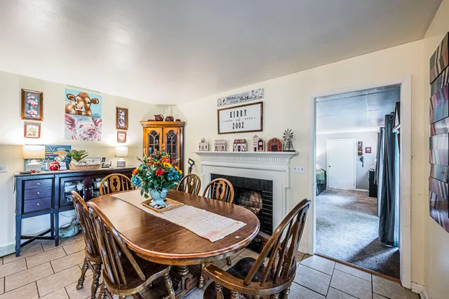 a view of a dining room with furniture and a chandelier