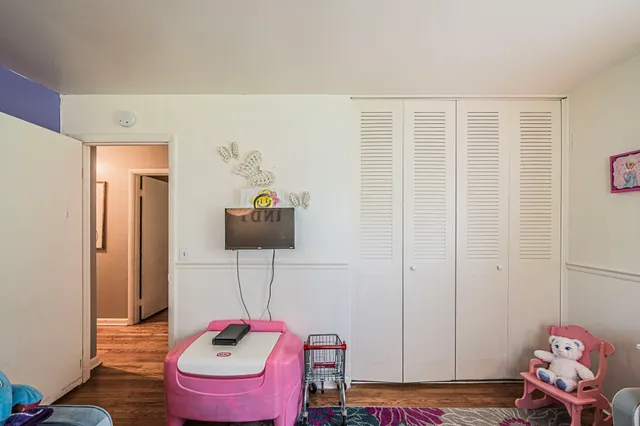 a hallway with a couch and a potted plant