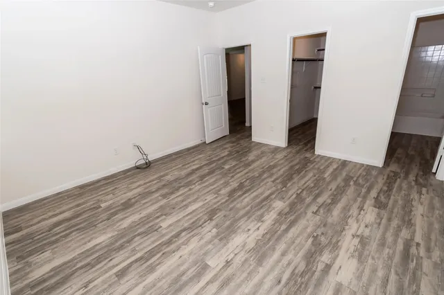 a view of a room with wooden floor and a window