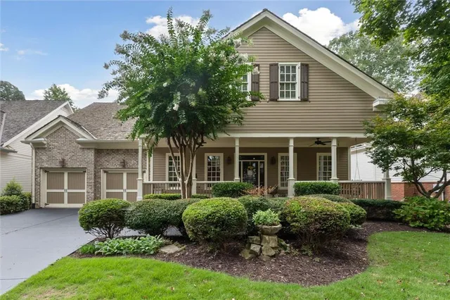 a view of a entryway door of the house with potted plants