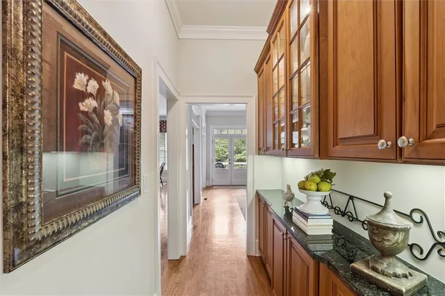 a spacious bedroom with a bed a dresser and a large window