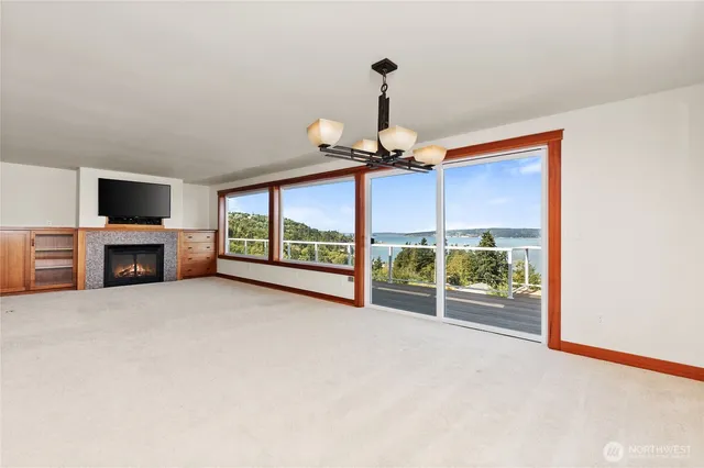 a living room with a fireplace and a flat screen tv