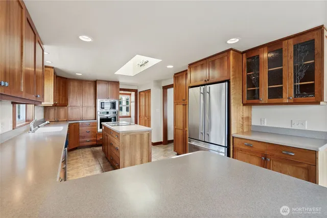 a kitchen with a stove sink and cabinets