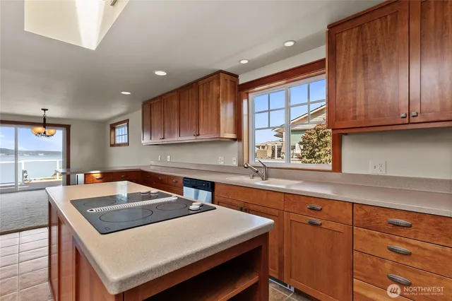 a kitchen with a sink a cabinets and wooden floor