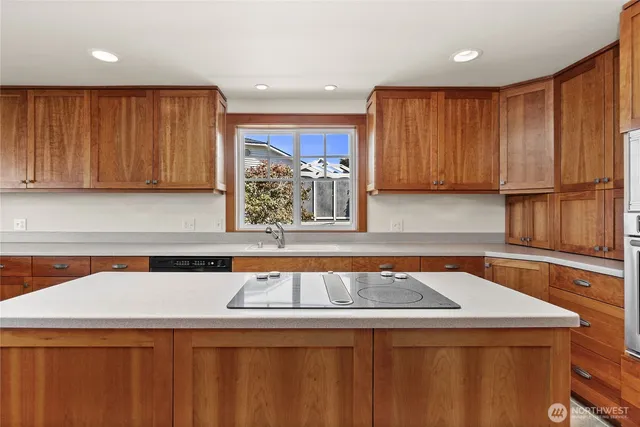 a kitchen with stainless steel appliances granite countertop a sink a stove and a refrigerator