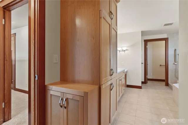 a spacious bathroom with a double vanity sink and a mirror