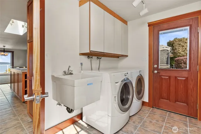 a view of staircase with railing and a window