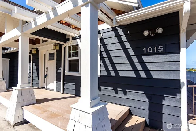 a view of a balcony with wooden floor and fence