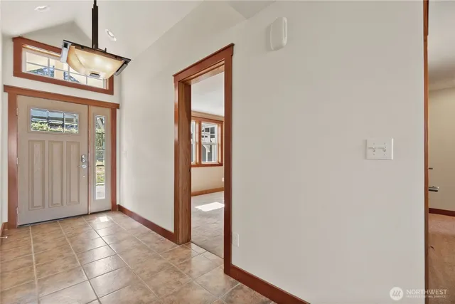 a view of entryway with wooden floor and windows
