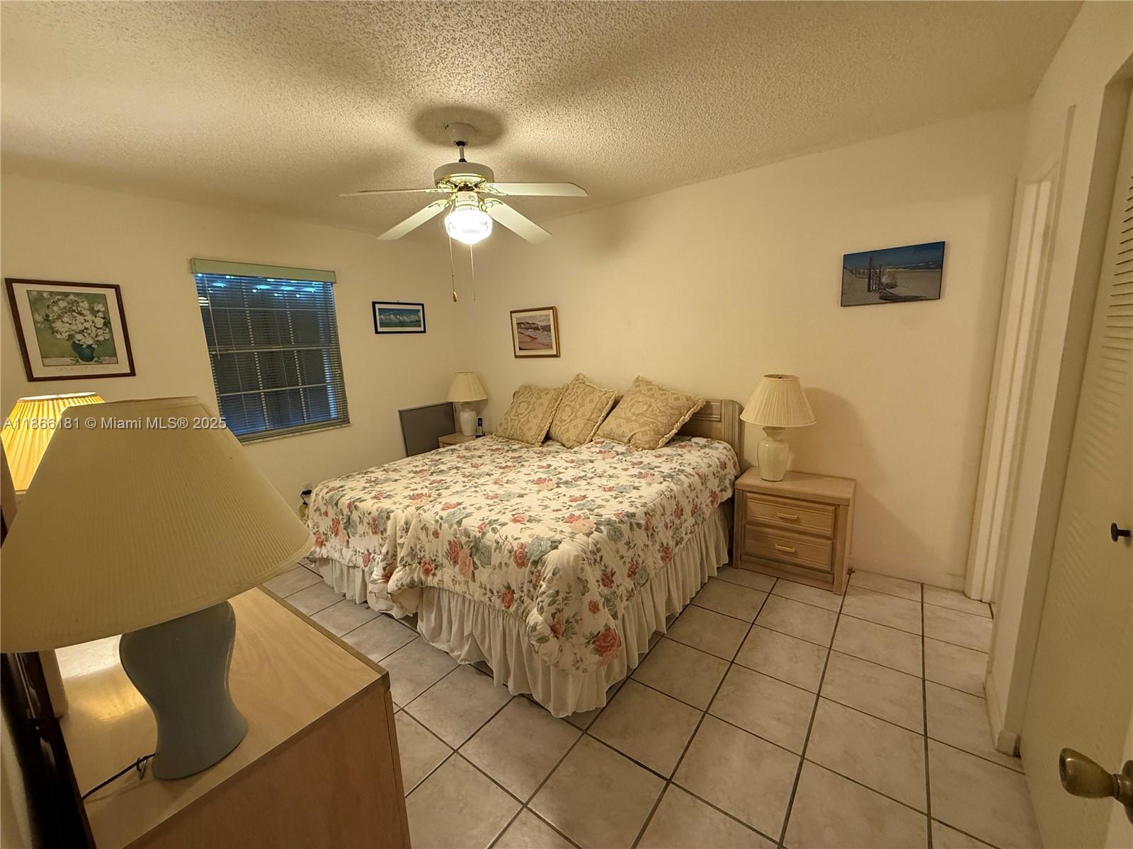 657 Waterside Drive, Unit 657 Hypoluxo, FL 33462 - Photo 11 of 17 a bedroom with a bed and window