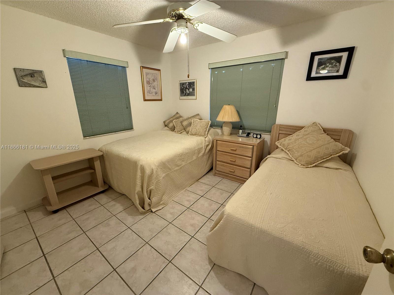 657 Waterside Drive, Unit 657 Hypoluxo, FL 33462 - Photo 13 of 17 a bedroom with a bed and a chandelier