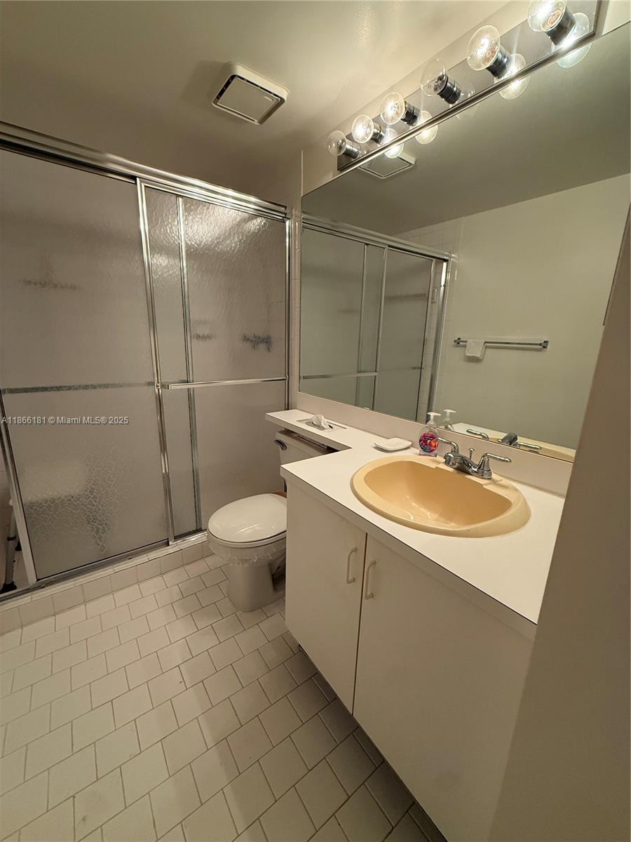 657 Waterside Drive, Unit 657 Hypoluxo, FL 33462 - Photo 17 of 17 a bathroom with a sink toilet and shower