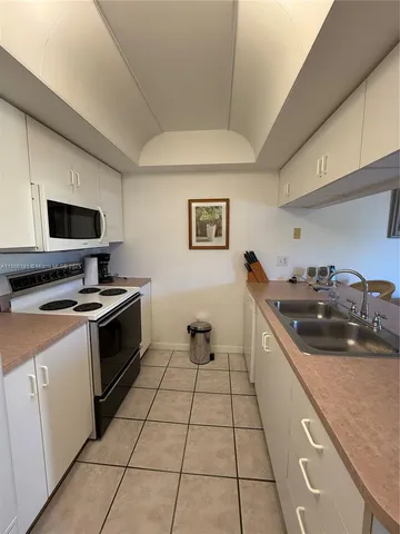 a kitchen with a sink and a stove top oven