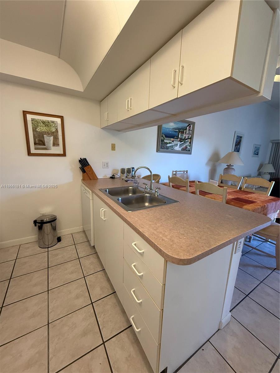 657 Waterside Drive, Unit 657 Hypoluxo, FL 33462 - Photo 4 of 17 a kitchen with stainless steel appliances a sink a stove a refrigerator and cabinets