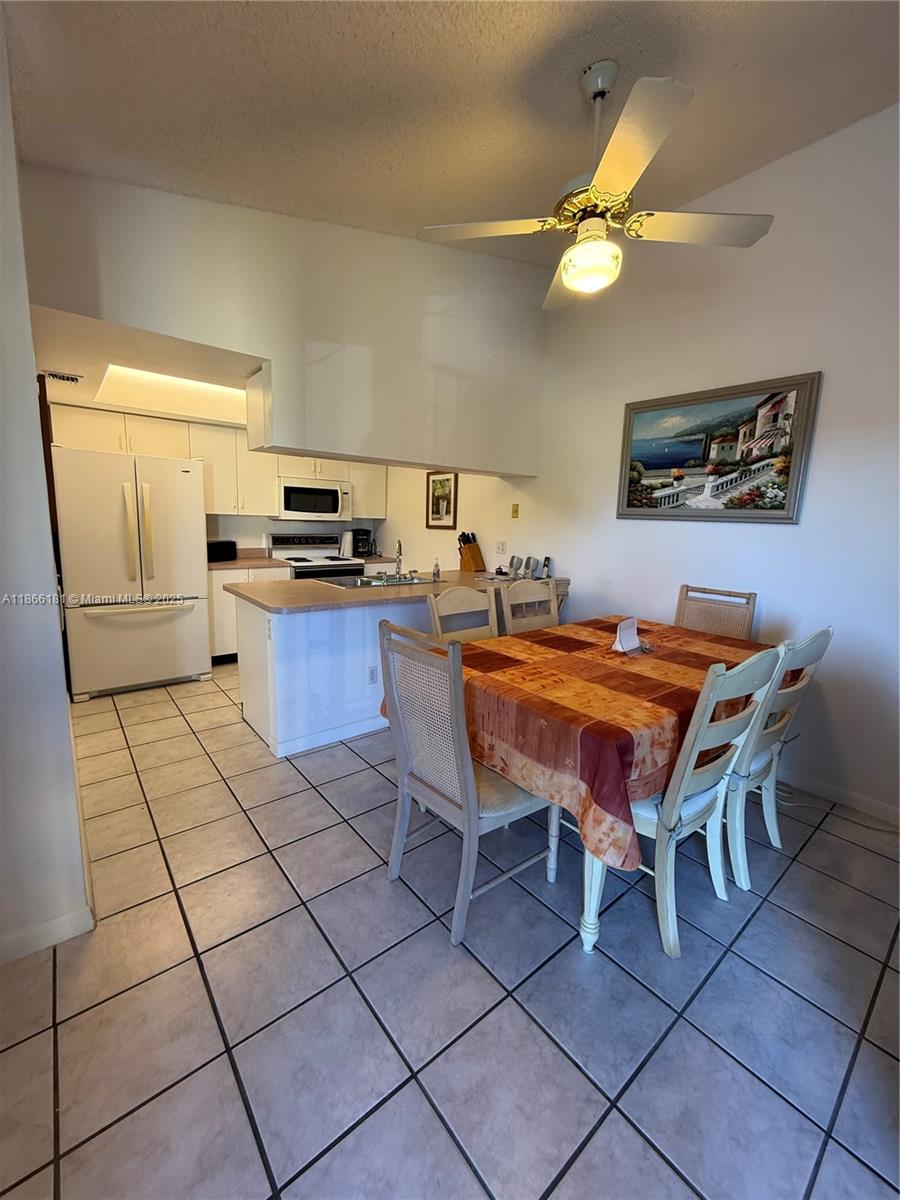 657 Waterside Drive, Unit 657 Hypoluxo, FL 33462 - Photo 8 of 17 a room with a dining table and chairs