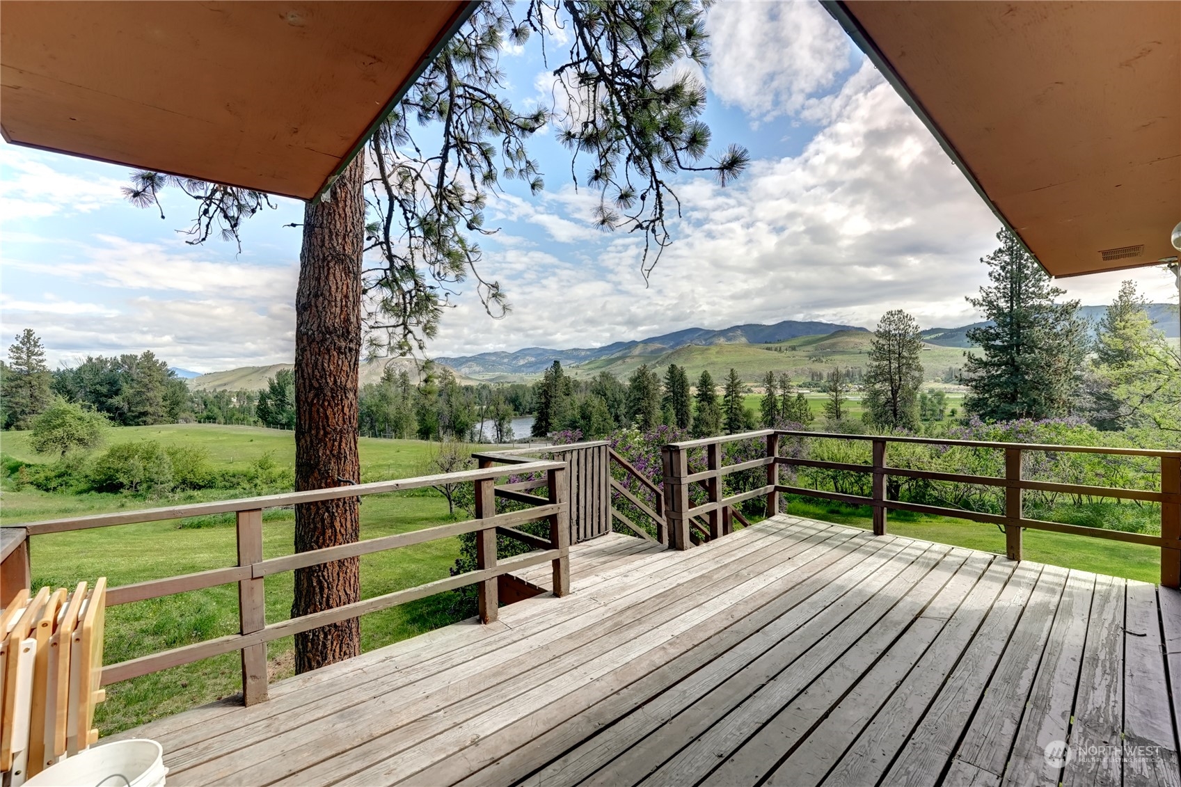 6 Rising Eagle Road Twisp, WA 98856 - Photo 13 of 40 a view of a balcony with wooden floor next to a yard