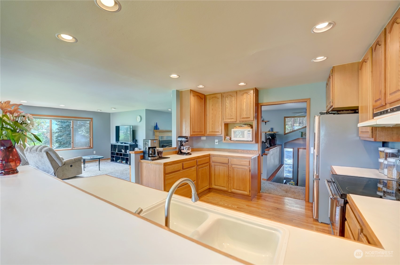 6 Rising Eagle Road Twisp, WA 98856 - Photo 16 of 40 a view of a kitchen with kitchen island a large window cabinets a sink and stainless steel appliances