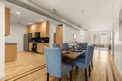 a dining room with furniture and wooden floor