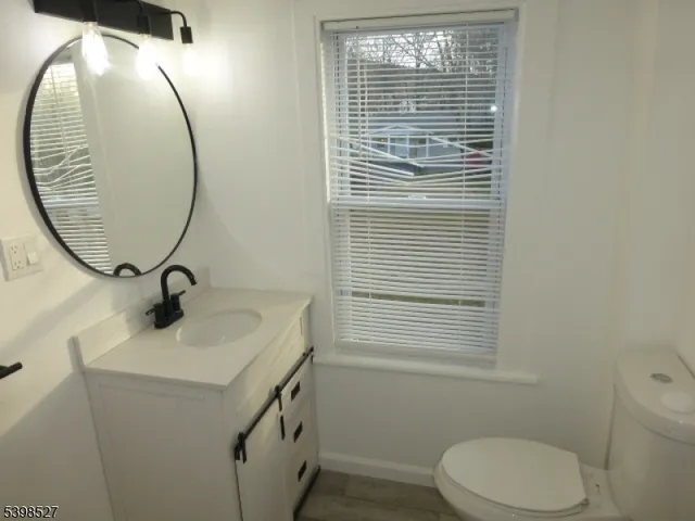 a view of a room with wooden floor and a window