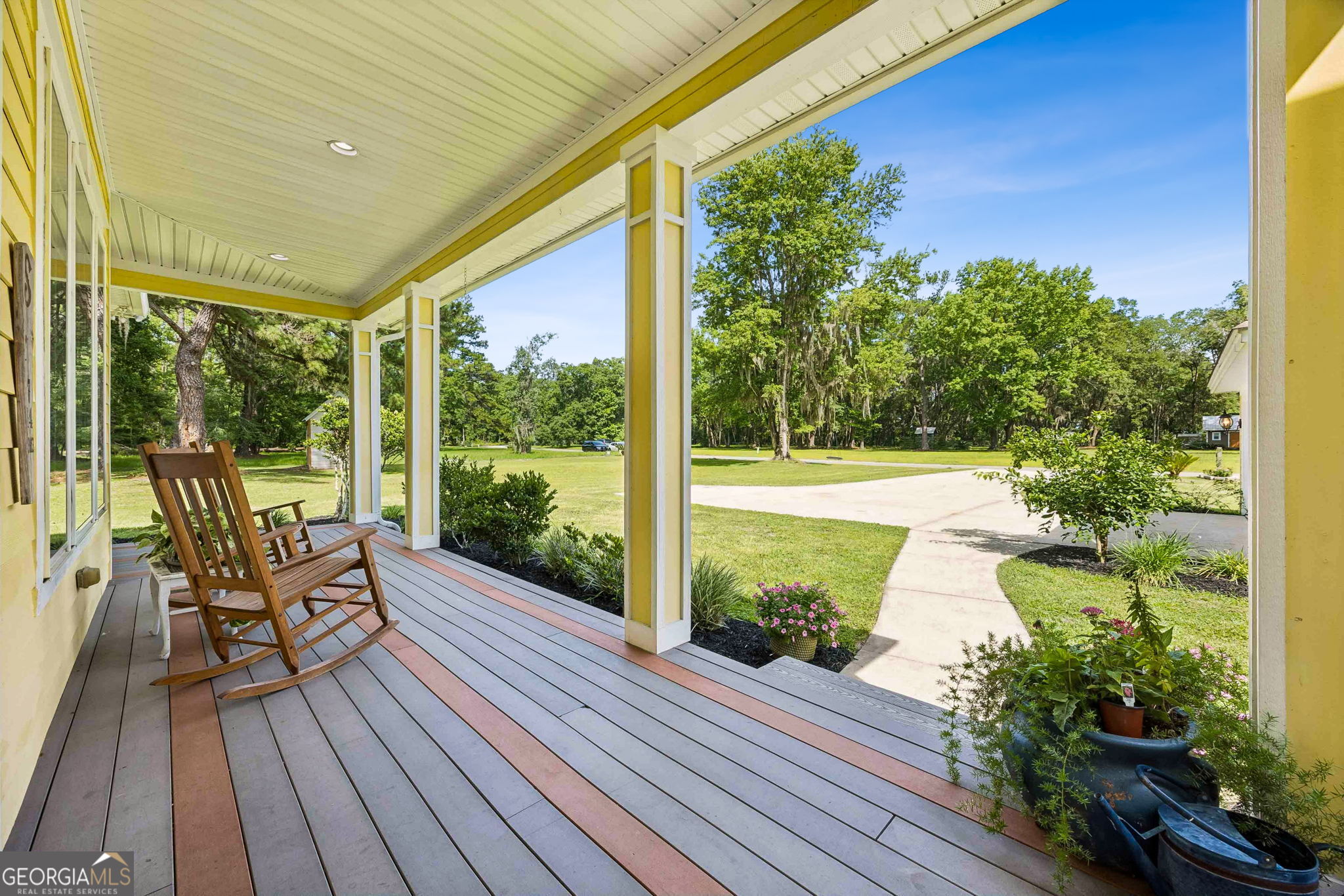 706 Hopewell Point Road White Oak, GA 31568 - Photo 60 of 84 Enjoy peaceful views of the front lawn and mature trees from the comfort of the wraparound porch, creating the perfect setting for morning coffee or evening relaxation.