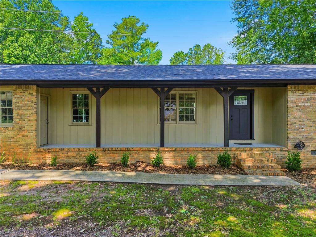 125 Childers Road Canton, GA 30115 - Photo 6 of 48 a front view of a house with garden