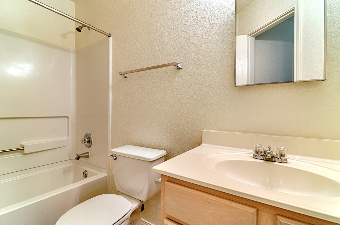 6433 Tara Drive Austin, TX 78747 - Photo 8 of 9 a bathroom with a sink toilet and shower