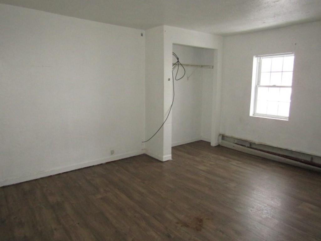 84 2nd Street California, PA 15419 - Photo 11 of 28 an empty room with wooden floor and windows