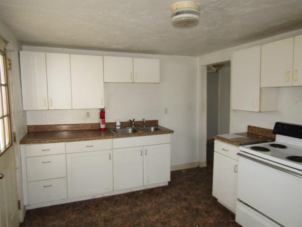 84 2nd Street California, PA 15419 - Photo 28 of 28 a kitchen with granite countertop a sink and a stove