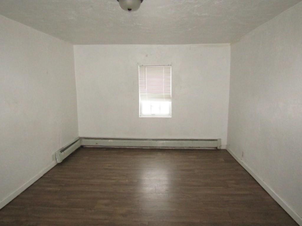 84 2nd Street California, PA 15419 - Photo 4 of 28 an empty room with wooden floor and windows