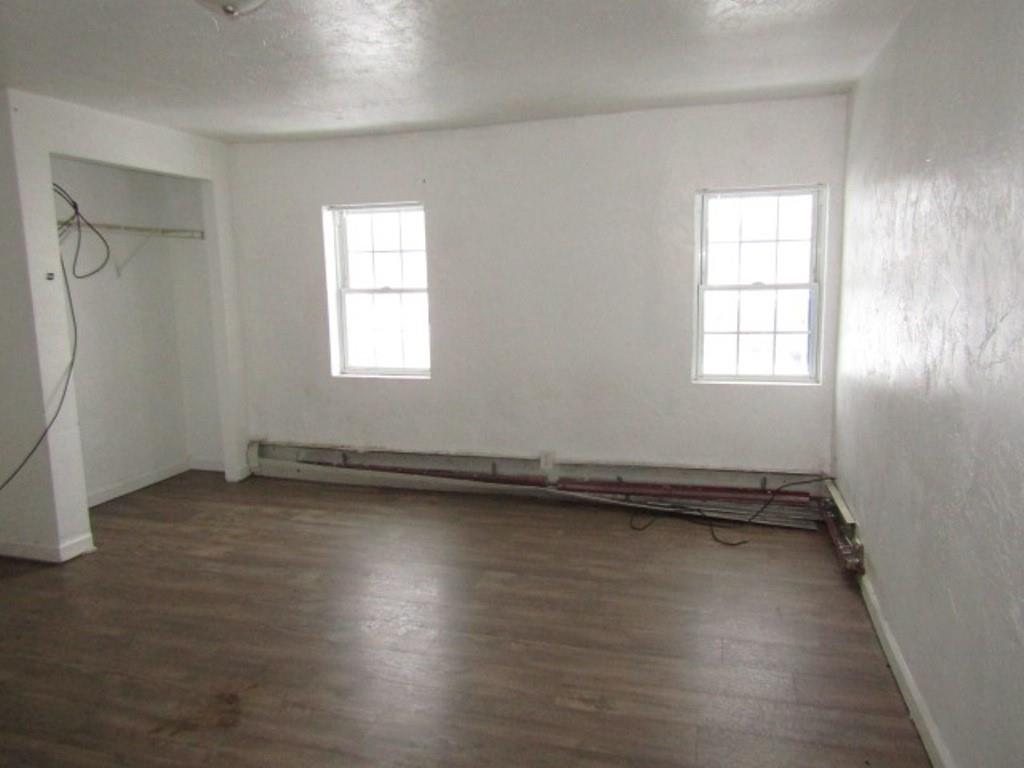 84 2nd Street California, PA 15419 - Photo 10 of 28 an empty room with wooden floor and windows