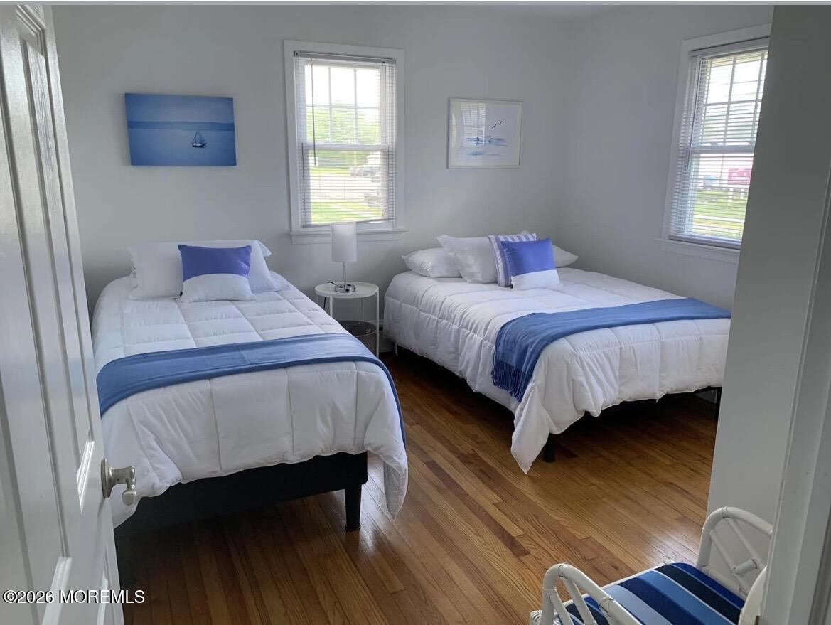 2001 Main Street Lake Como, NJ 07719 - Photo 14 of 26 a bedroom with a bed and wooden floor