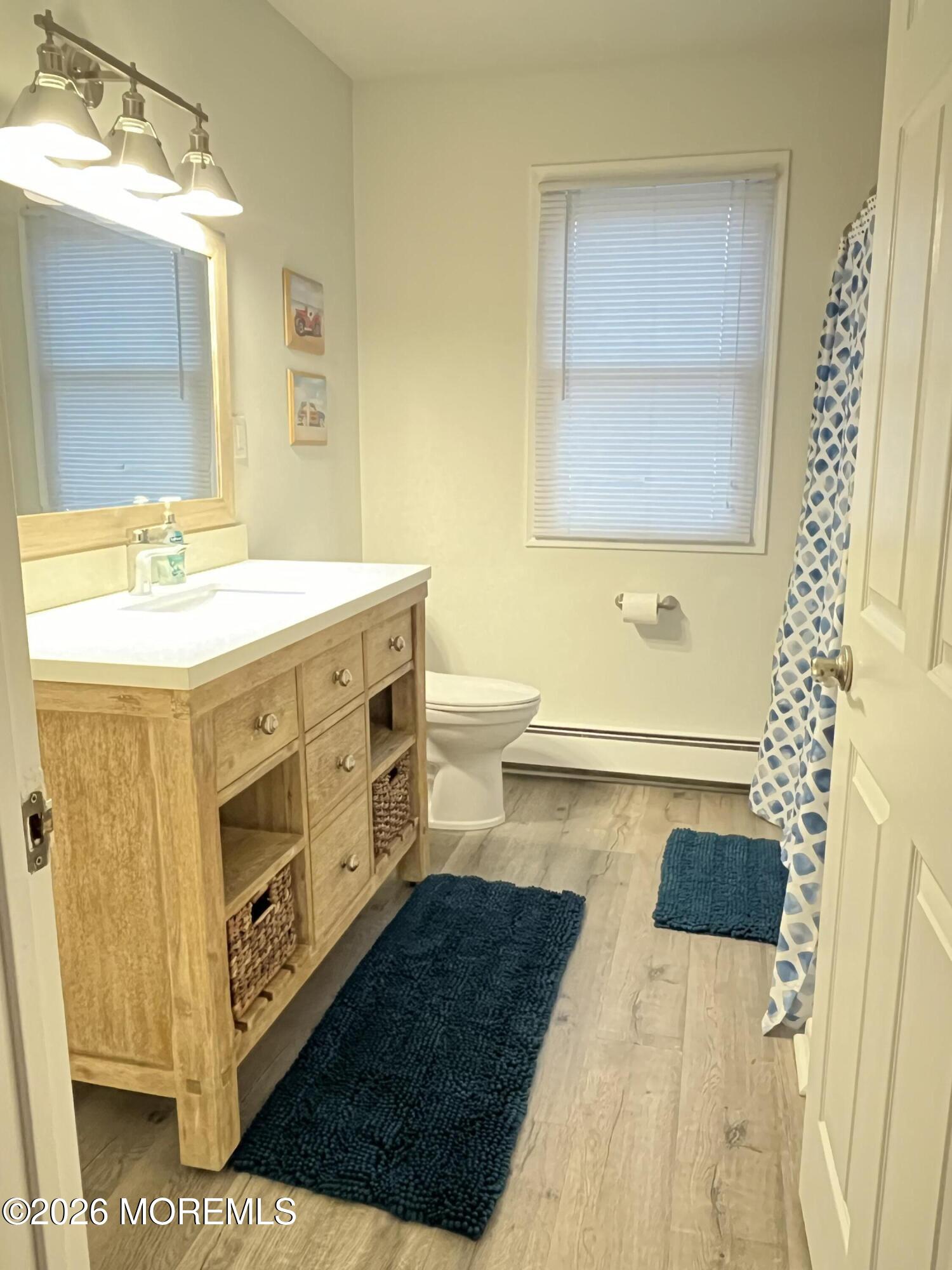 2001 Main Street Lake Como, NJ 07719 - Photo 16 of 26 a bathroom with a double vanity sink a toilet and a mirror