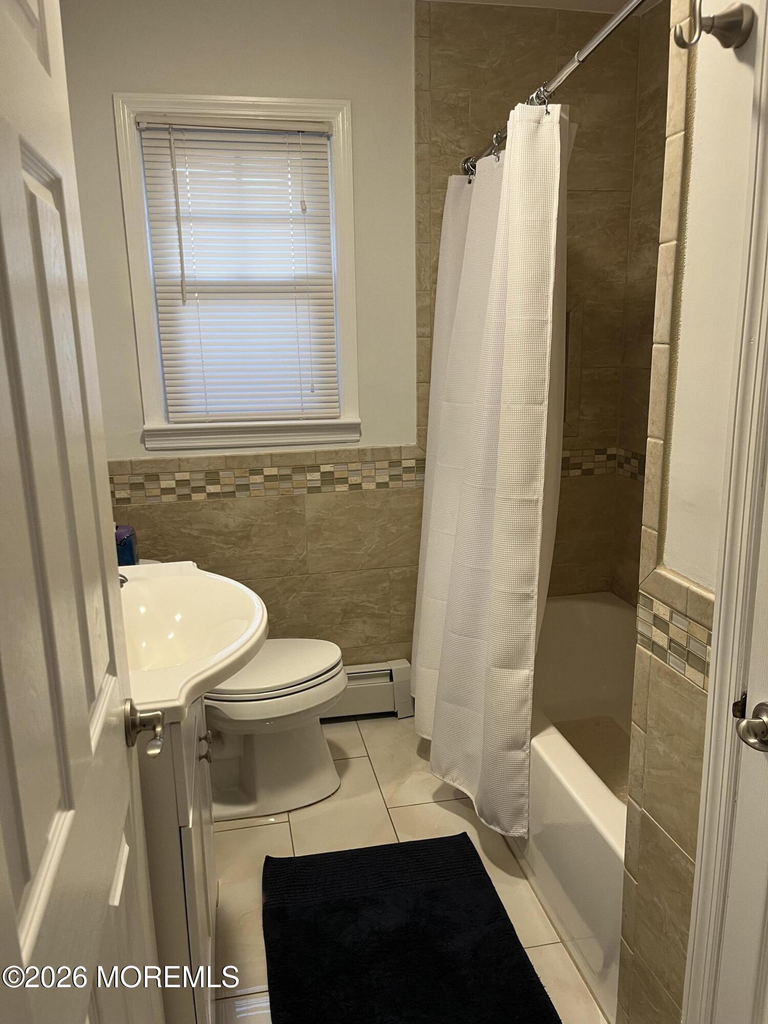 2001 Main Street Lake Como, NJ 07719 - Photo 17 of 26 a bathroom with a sink a toilet a window and vanity