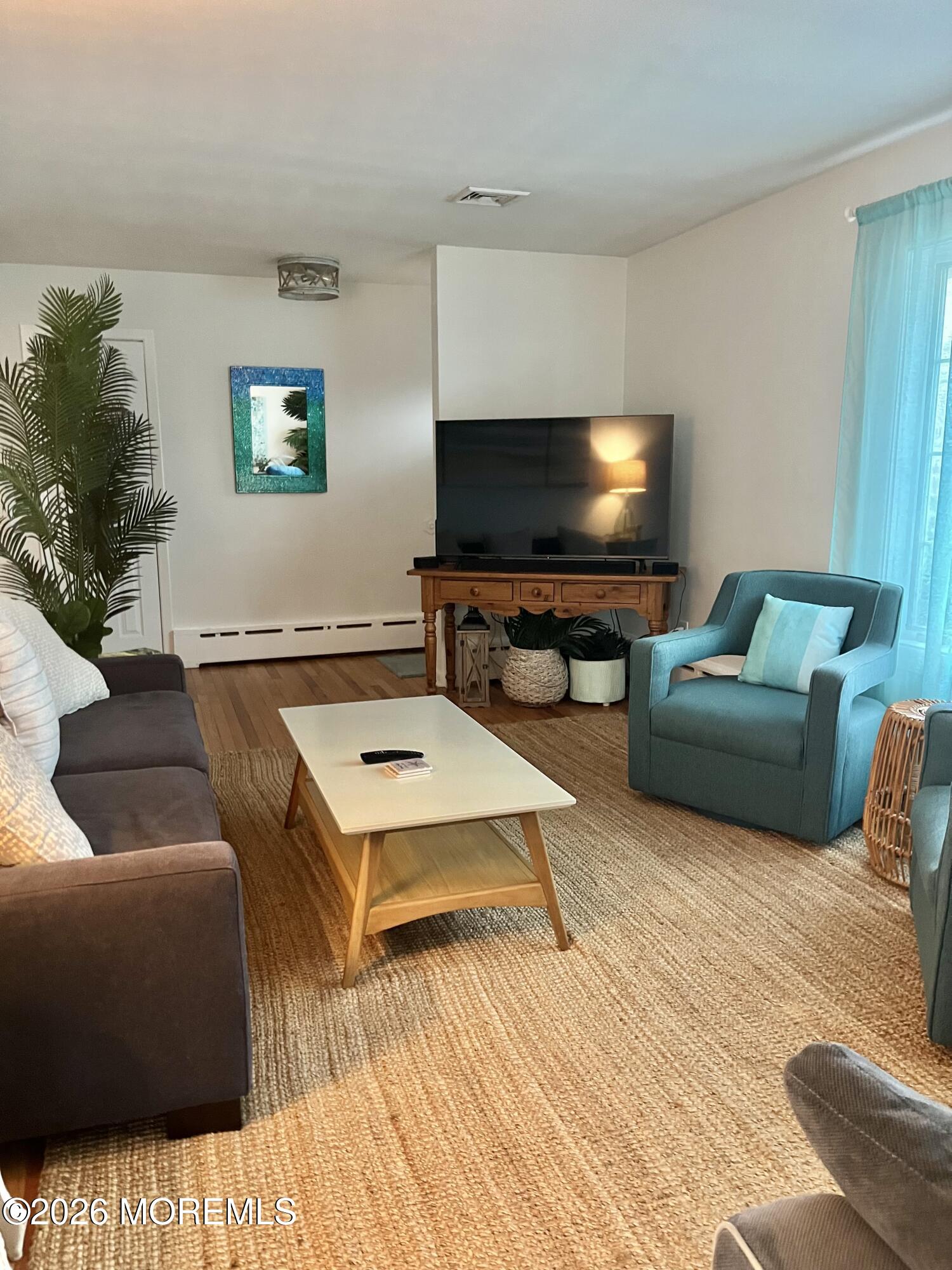 2001 Main Street Lake Como, NJ 07719 - Photo 2 of 26 a living room with furniture and a flat screen tv