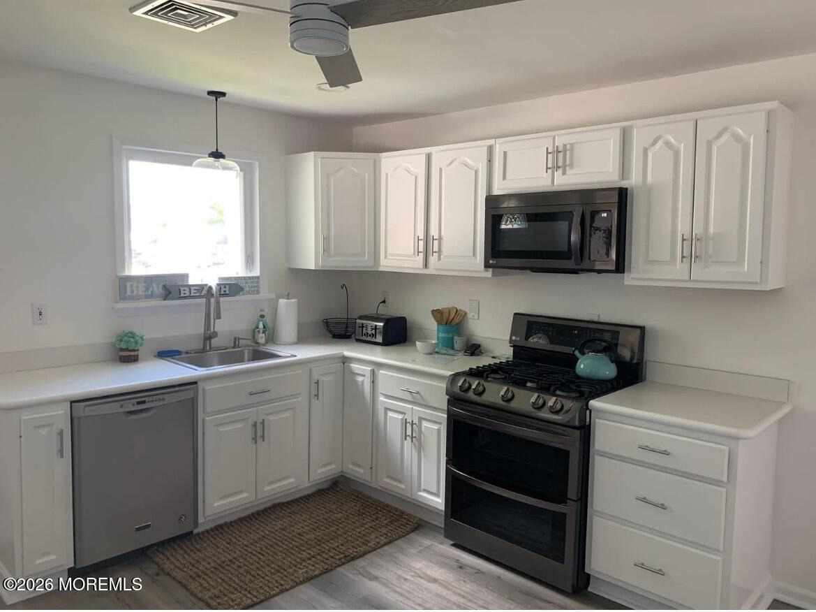 2001 Main Street Lake Como, NJ 07719 - Photo 4 of 26 a kitchen with a sink stove top oven and microwave