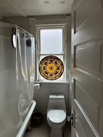 a bathroom with a toilet and a shower