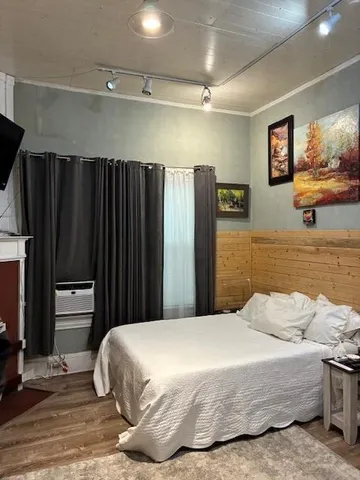 a bedroom with a bed and cabinets