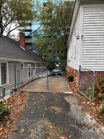 a backyard of a house with table and chairs