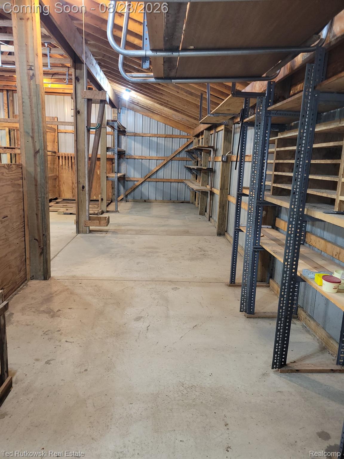 12350 Masters Road Memphis, MI 48041 - Photo 45 of 45 Concrete flooring with exposed wooden support beams, metal wall panels, and built-in shelving