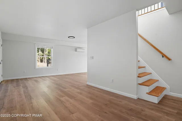 a living room with furniture a rug and a window