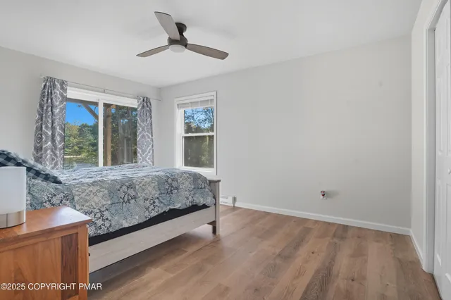 a bedroom with a bed and large window