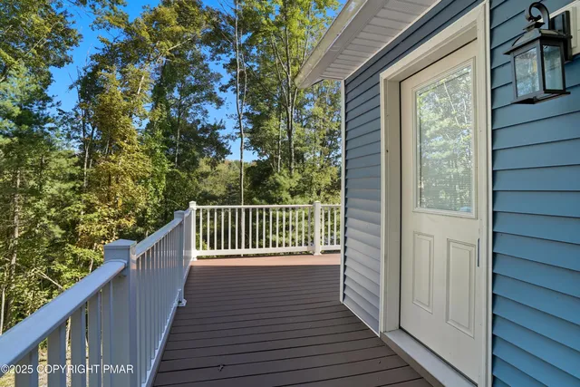 a balcony with wooden floor and fence