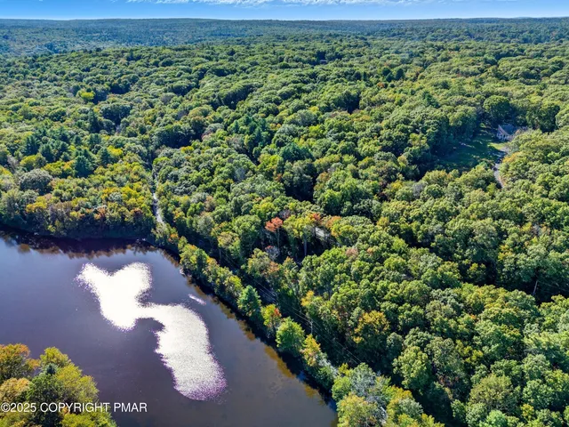 an aerial view of a houses with a yard