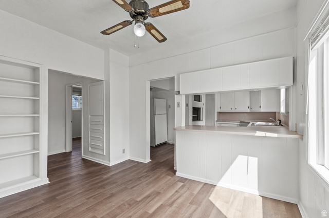 180 South 300 East Logan, UT 84321 - Photo 6 of 35 Kitchen featuring built in features, light countertops, freestanding refrigerator, and a peninsula