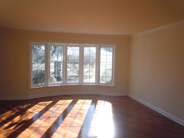 1752 East Corktree Lane Mount Prospect, IL 60056 - Photo 2 of 20 a view of an empty room with wooden floor and a window