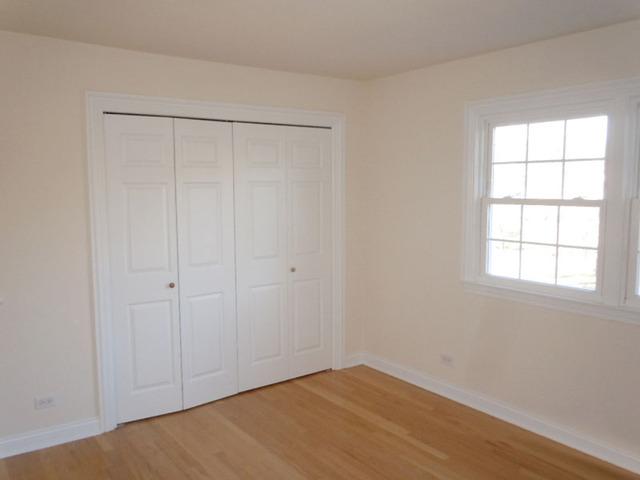 1752 East Corktree Lane Mount Prospect, IL 60056 - Photo 11 of 20 wooden floor in an empty room with a window
